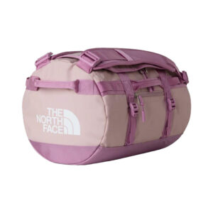 Ein rosafarbener Seesack mit lilafarbenen Trägern und weißem "The North Face"-Logo auf der Seite, abgebildet auf weißem Hintergrund.